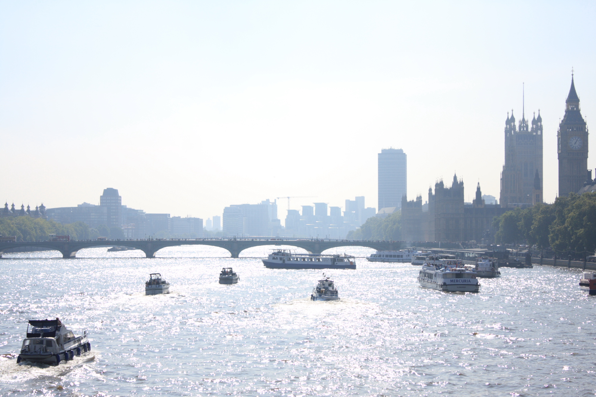 Hazy view down the Thames towards Parliament taken from Hungerford Bridge