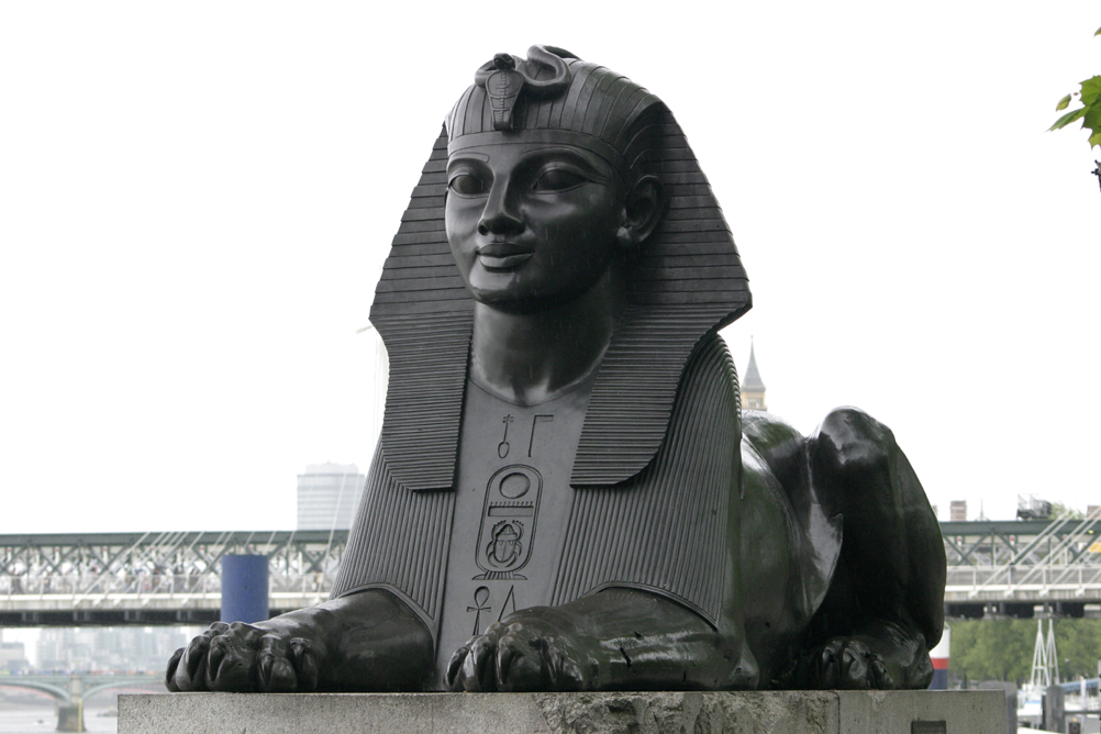 One of the Sphinx flanking Cleopatras Needle, shrapnel damage from WW2 air raids can be seen on the paw and pedestal.