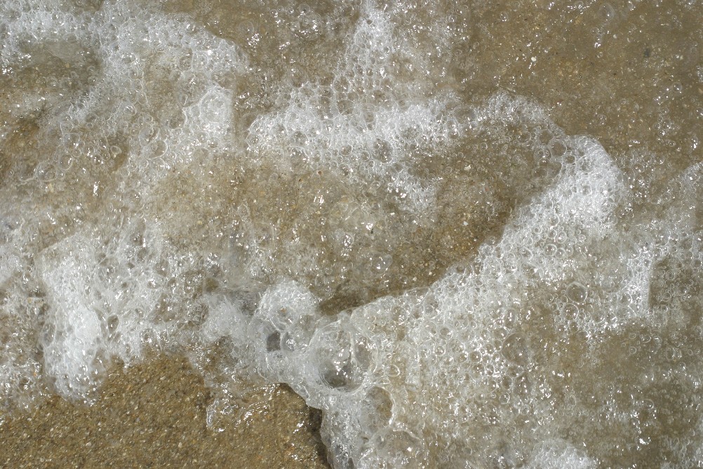 Wave foam left on the beach.